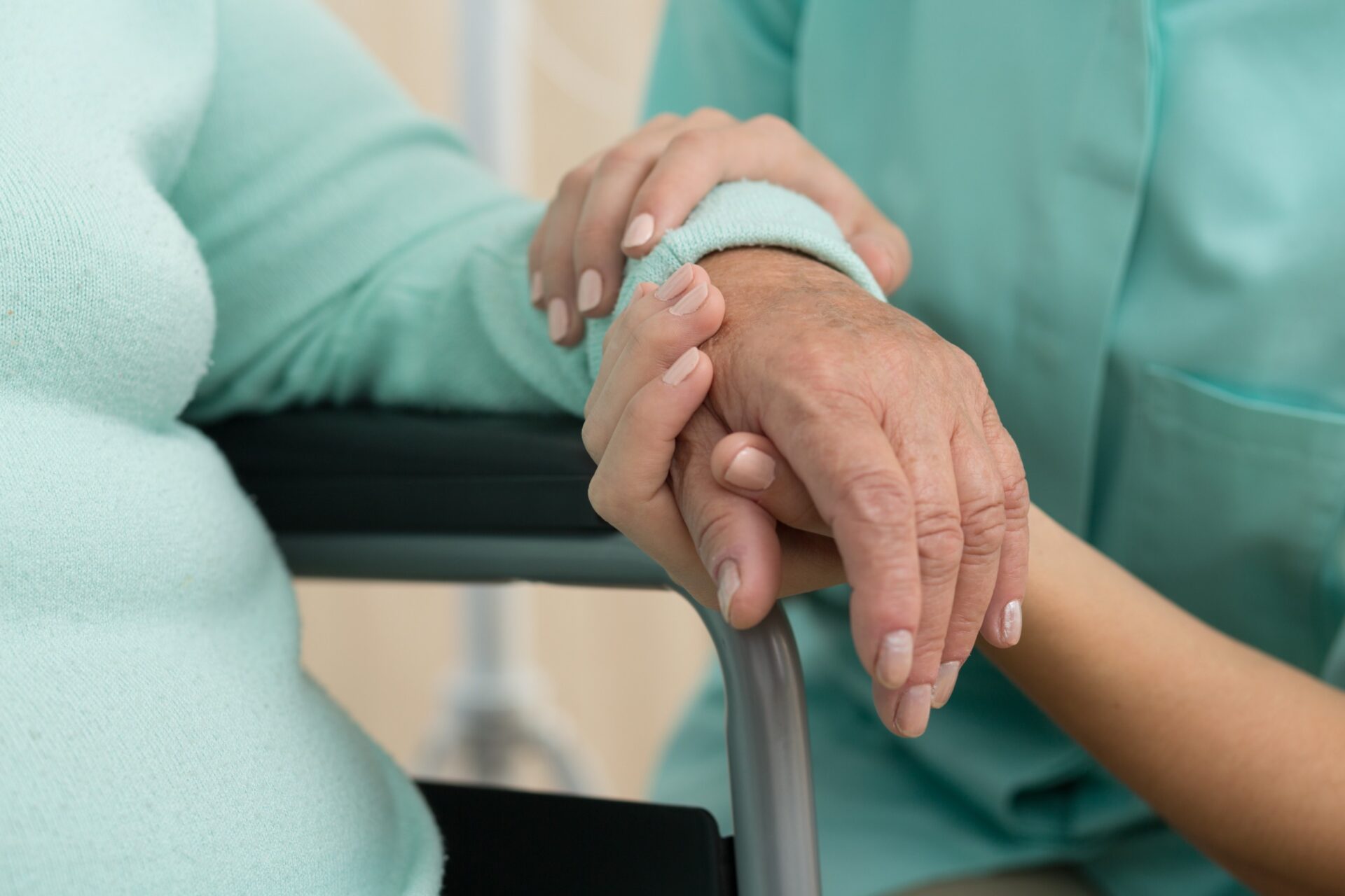 Photo of nurse supporting old woman on wheelchair Photo of nurse supporting old woman on wheelchair